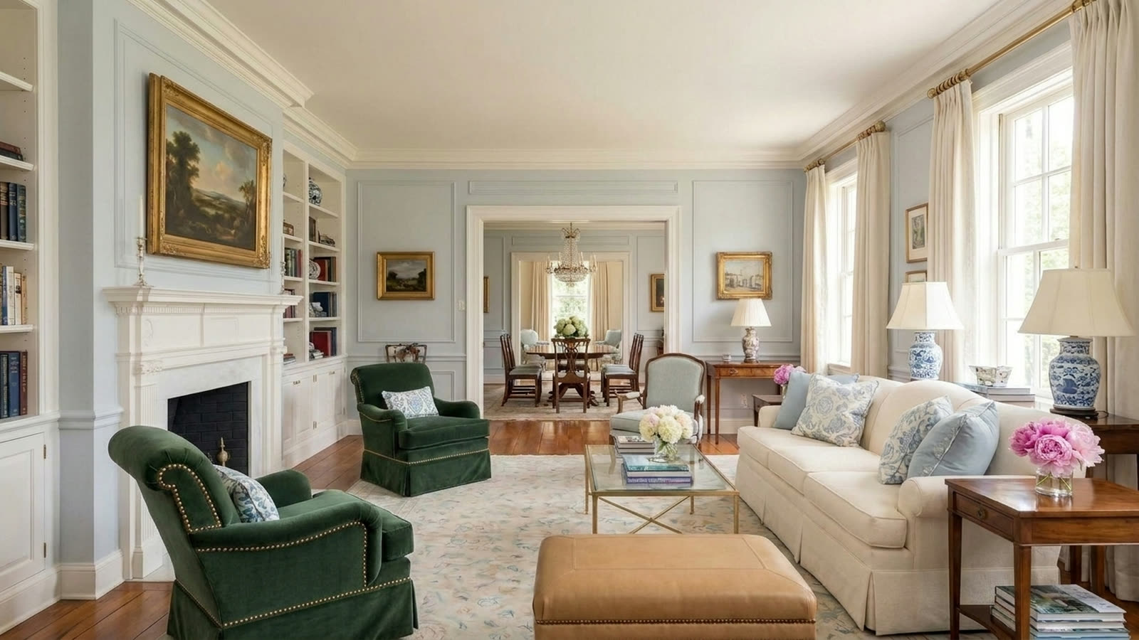 The same living room with the armchairs replaced by deep green velvet club chairs.