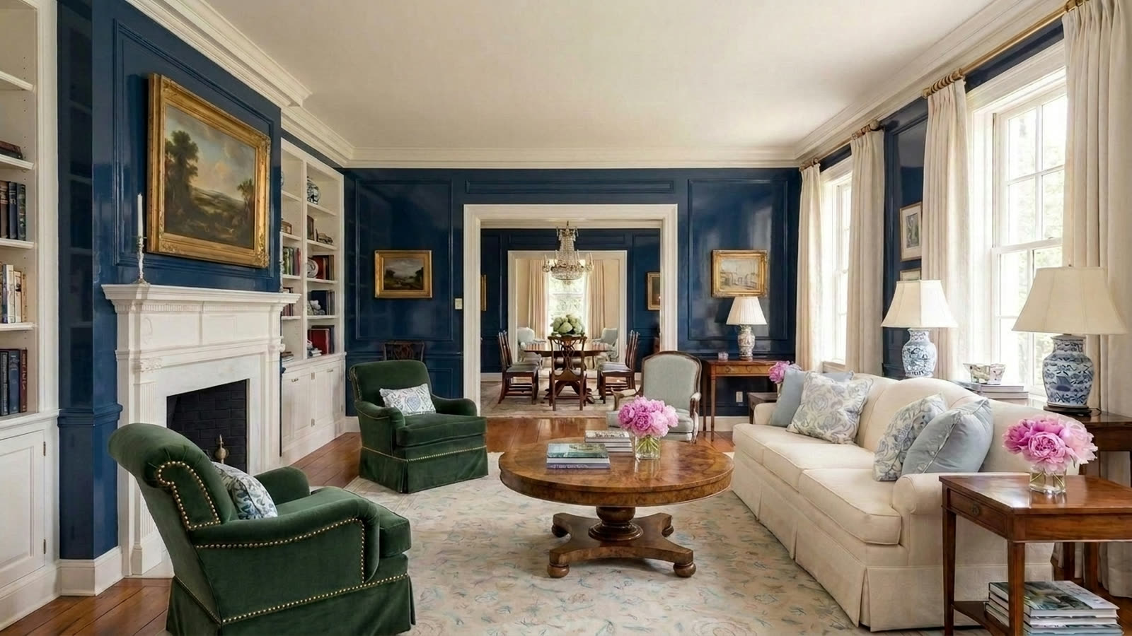 The same living room with a round burl walnut coffee table in place of the brass and glass one.