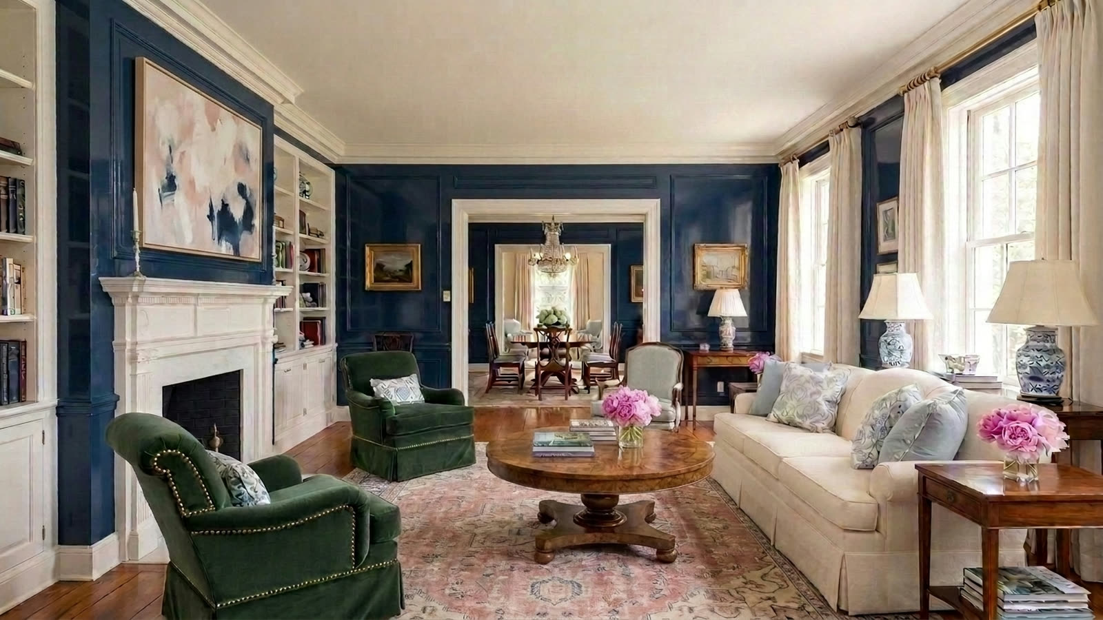 The same living room with a large contemporary abstract painting above the fireplace.